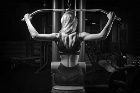 Charming Blonde Does Exercises For The Back In The Gym