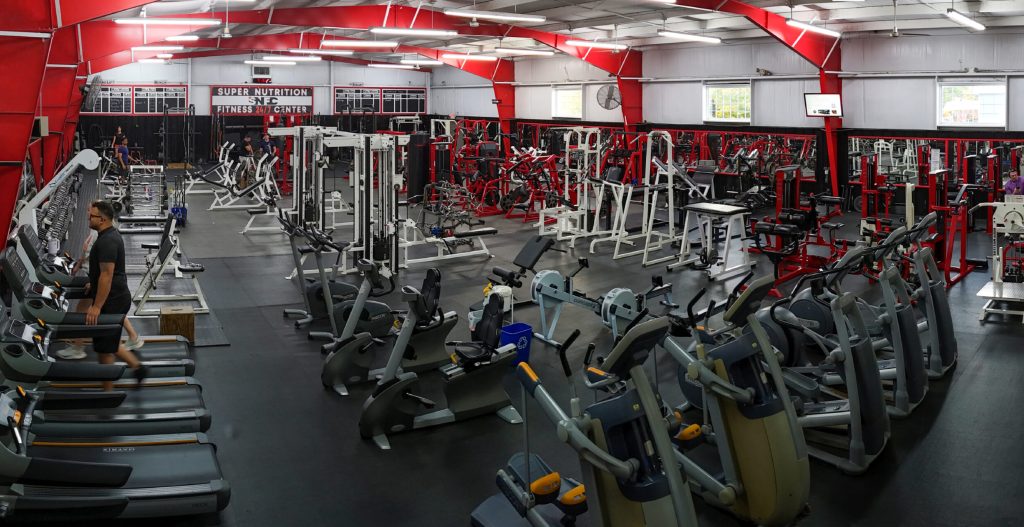 Big modern fitness gym with dumbbells 